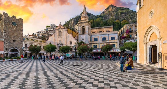Taormina and San Giuseppe church on the square Piazza IX Aprile in Taormina. Sicily, Italy. Square Piazza IX Aprile with San Giuseppe church and Clock Tower in Taormina, Sicily, Italy.