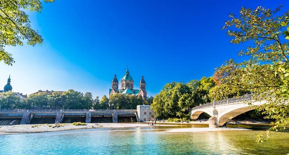 Photo of St. Luke's Church Lukaskirche, and isar river in summer landscape of Munich, Bavaria, Germany.