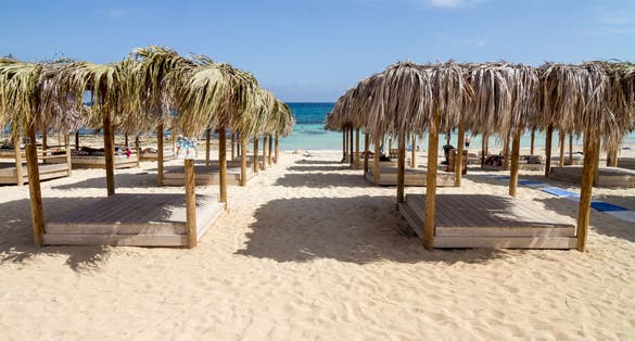 Photo of beautiful Makronissos Beach with umbrellas and sunbeds ,Cyprus.