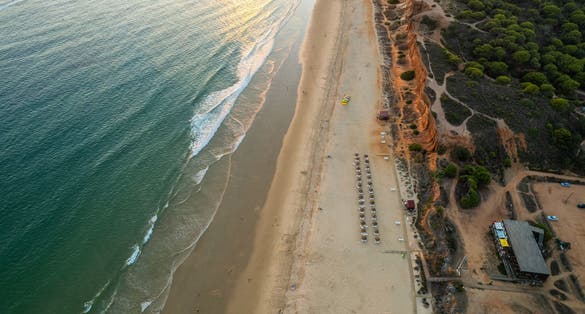 Praia da Falesia, Algarve beach in Albufeira, Portugal. Aerial drone view at sunset