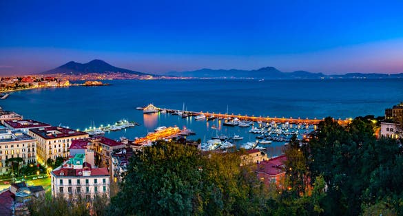 photo of Naples, Italy. Beautiful sunset lights over the Naples' Bay with the marina in foreground and Mount Vesuvius far in the background.,Ottaviano Italy.