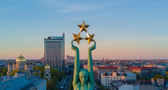photo of gorgeous view of the statue of liberty milda in Riga during sunset, Latvia.
