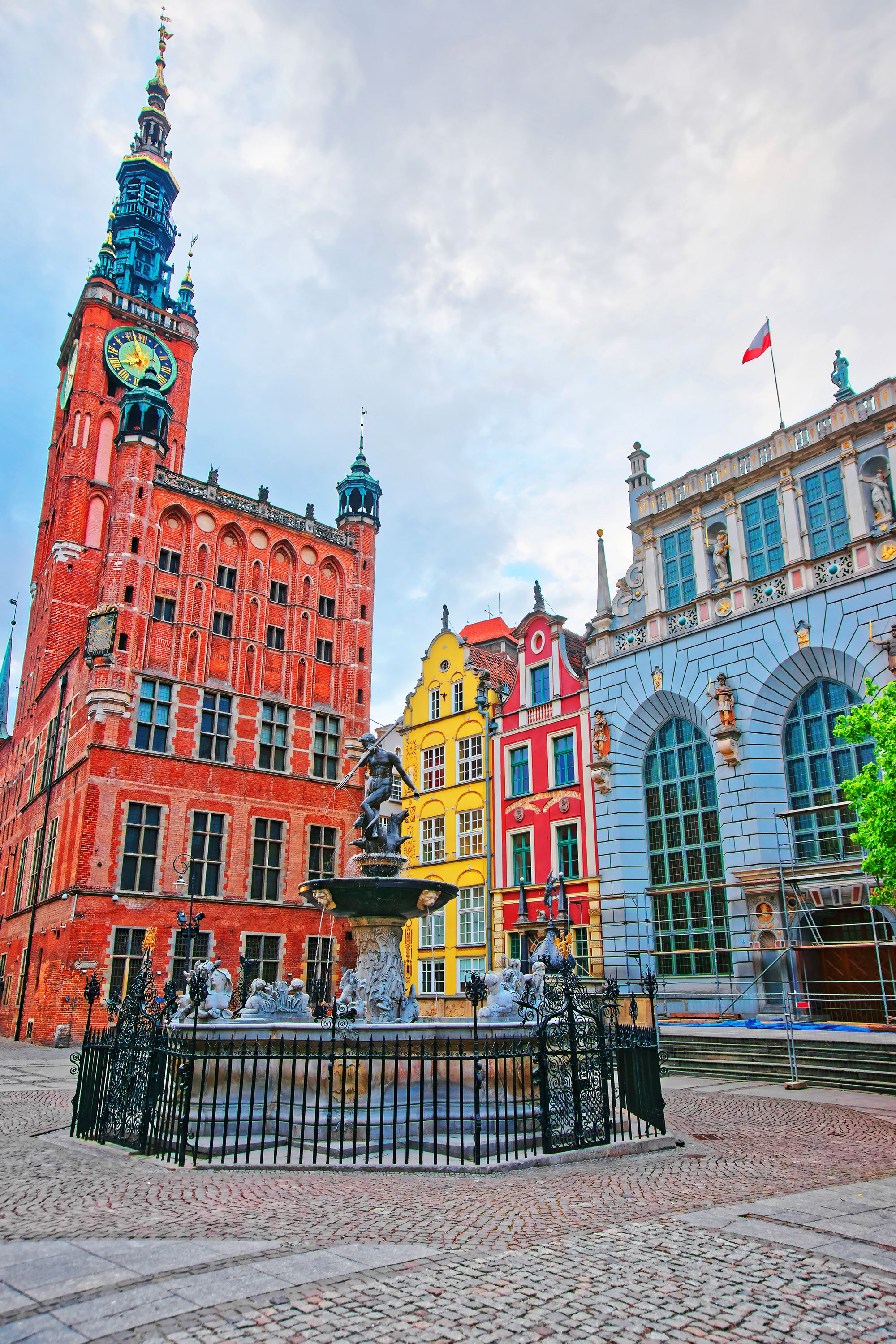 Neptune fountain at Main City Hall and Dlugi Targ Square in the old city center of Gdansk, Poland. People on the background.