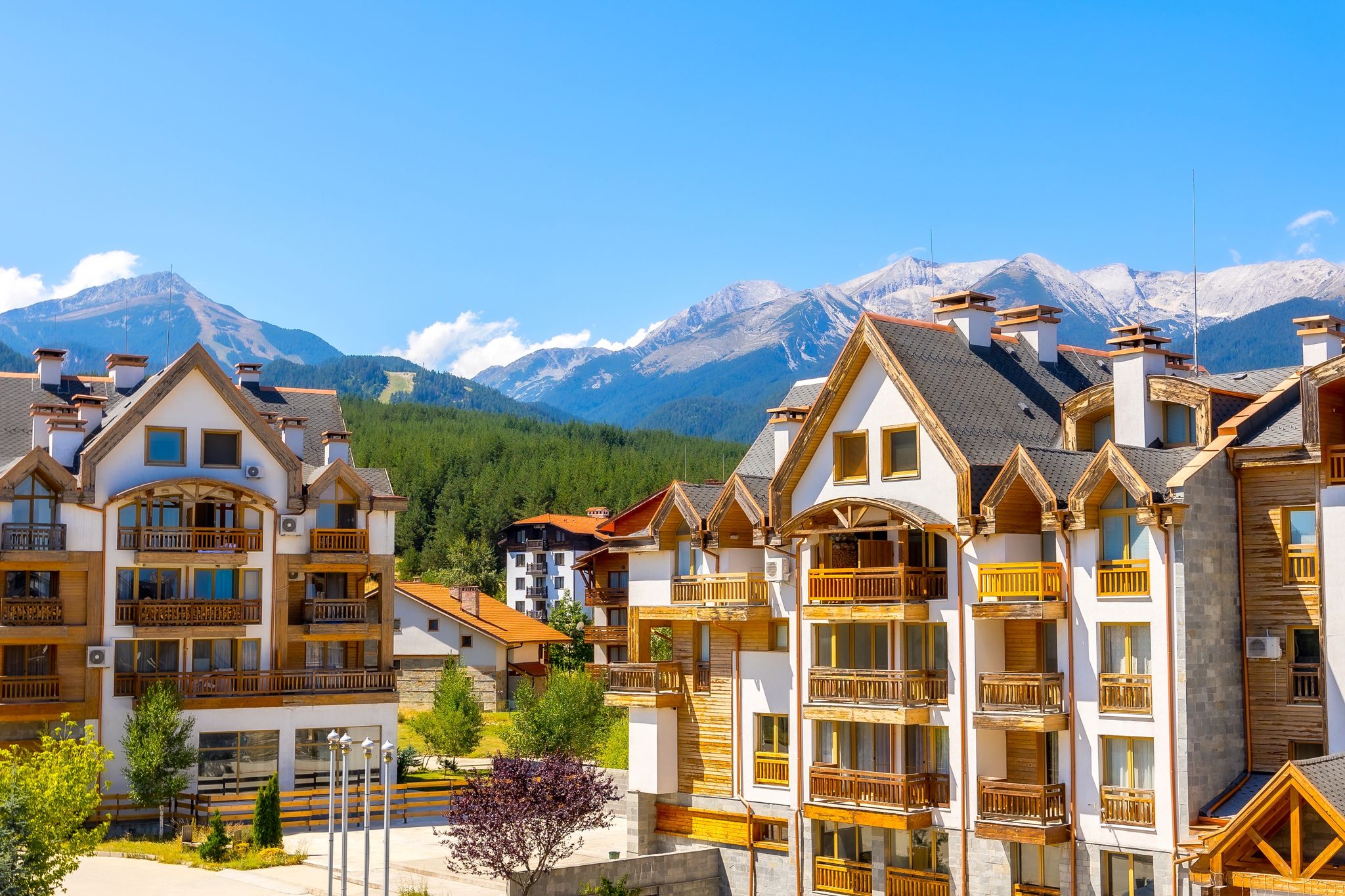 Photo of Bansko, Bulgaria summer view with houses and Pirin peaks panorama.