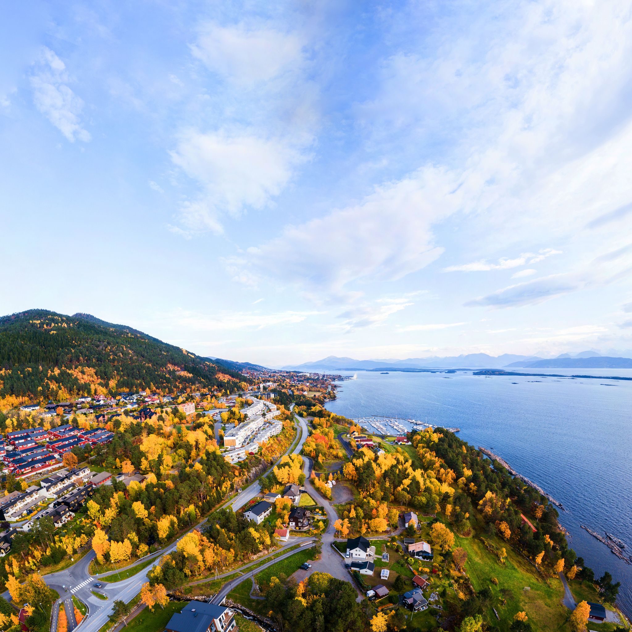 photo of view of Molde, Norway. Aerial view of residential area in Molde, Norway in the evening. Beautiful fjord with mountains in autumn