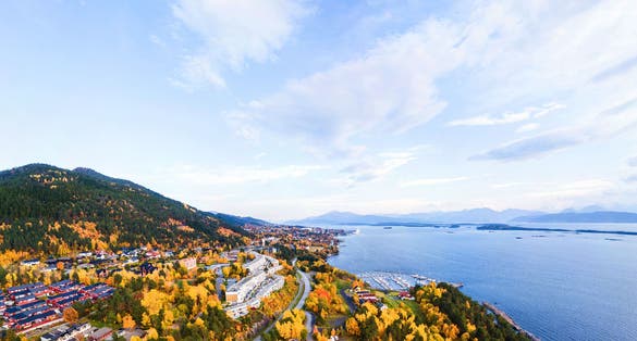 photo of view of Molde, Norway. Aerial view of residential area in Molde, Norway in the evening. Beautiful fjord with mountains in autumn