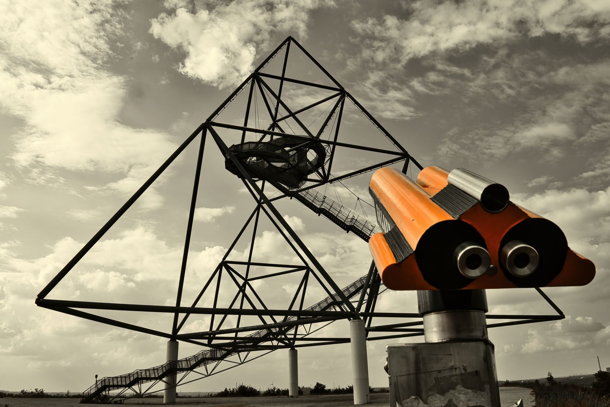 photo of view of the Tetraeder in Bottrop behind a paid binoculars.