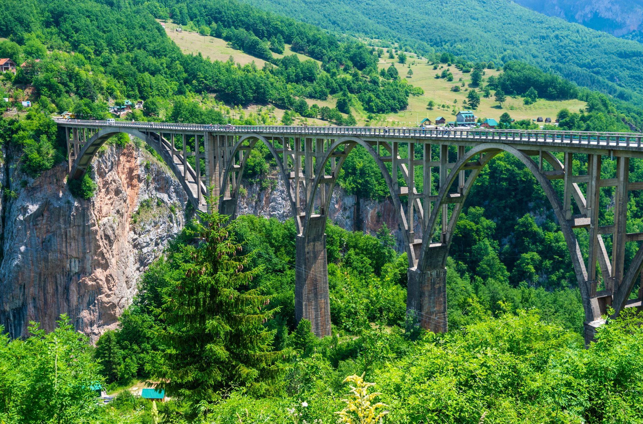 Photo of aerial view of Djurdjevica Tara Bridge is a concrete arch bridge over the Tara River in northern Montenegro. 365m long and the roadway stands 172 metres above the river.