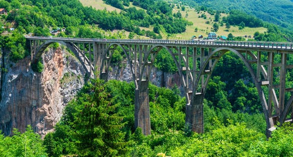 Photo of aerial view of Djurdjevica Tara Bridge is a concrete arch bridge over the Tara River in northern Montenegro. 365m long and the roadway stands 172 metres above the river.