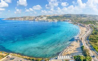 Photo of panoramic aerial view of St. Paul bay with acropolis of Lindos in background ,Rhodes, Greece.