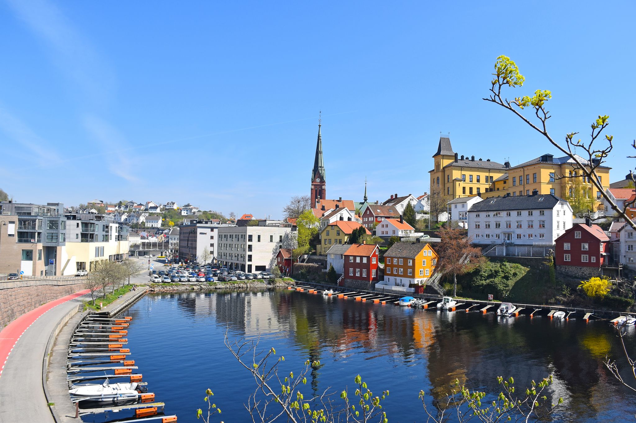 Sea view over the sea. Arendal city, Norway. city view, Arendal, Norway in the spring time on the nice sunny day. boats sit moored at the city habour With colorful house along the sea.