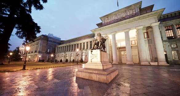 Photo of the Prado Museum at night, Madrid, Spain.