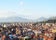 Photo of panoramic aerial view to Korca, the town in southwest of Albania, the mountains and the red tile roofs of its buildings.