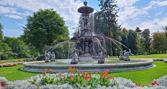 Photo of beautiful fountain in the city park Stadtpark, a green island in the middle of the city center of Graz, Austria.