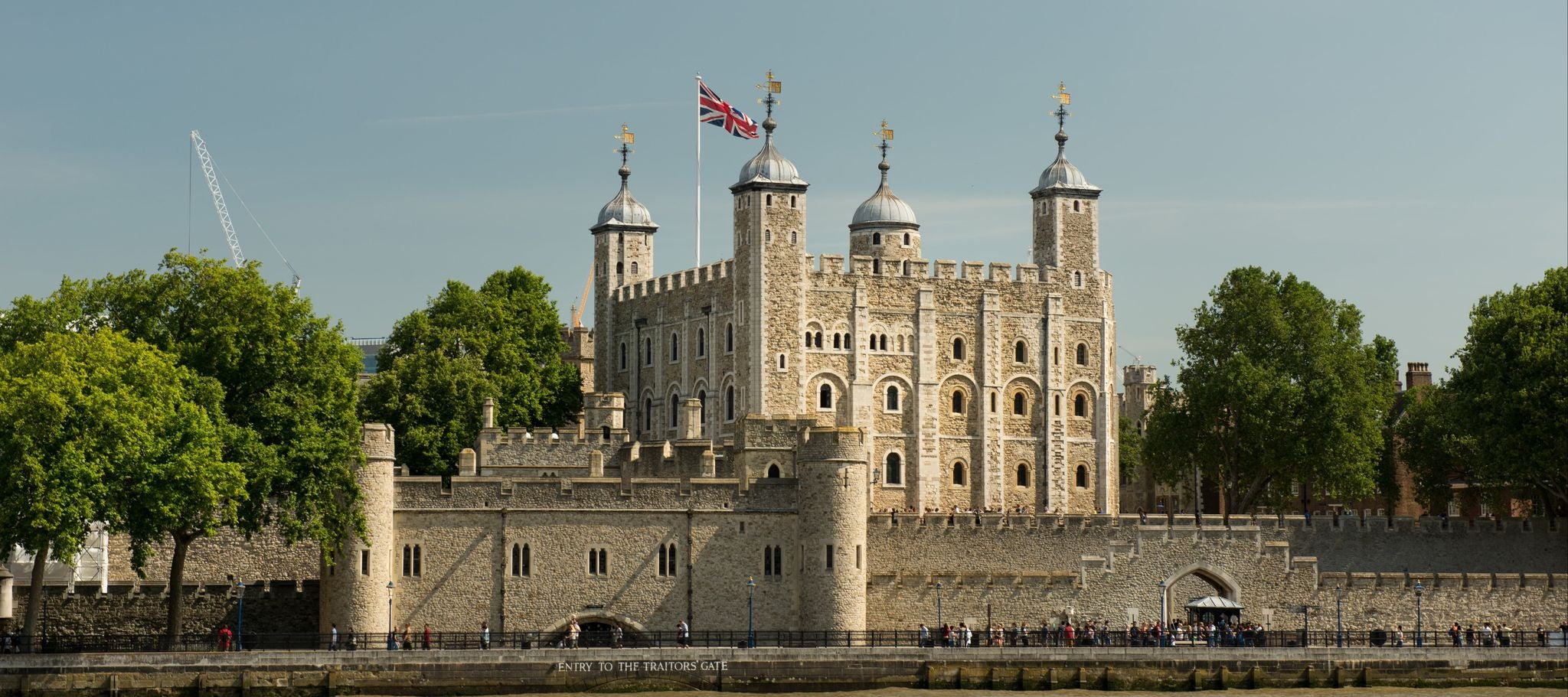 Tower of London with Union Jack flying above, viewed from across the River Thames on a sunny day..jpg