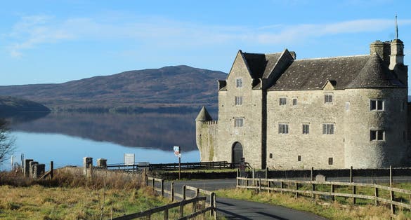 photo of Landscape at Kilmore, County Leitrim, Ireland featuring Parke's Castle, a 17th century castle on shores of Lough Gill with Killery Mountain in background .