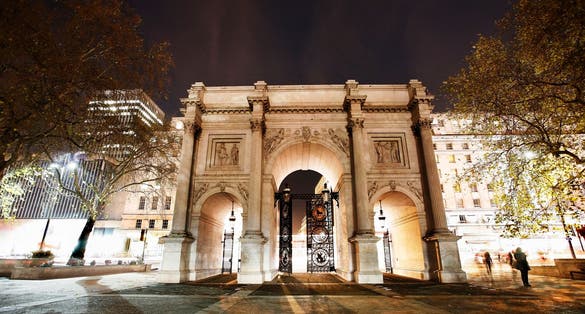 Photo of the Marble Arch at night, designed in 1825 by John Nash, completed in 1833, located in central London, UK.