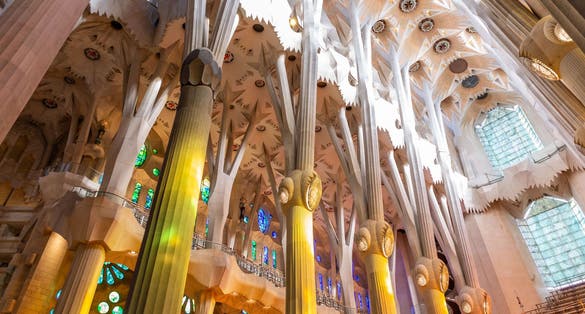 Photo of view from the astonishing interior of La Sagrada Familia, a large unfinished minor basilica in the Eixample district of Barcelona, Catalonia, Spain.