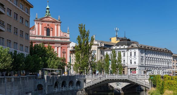 A picture of Ljubljana and the margins of the Ljubljanica river, centered on Prešeren Square and the Triple Bridge.