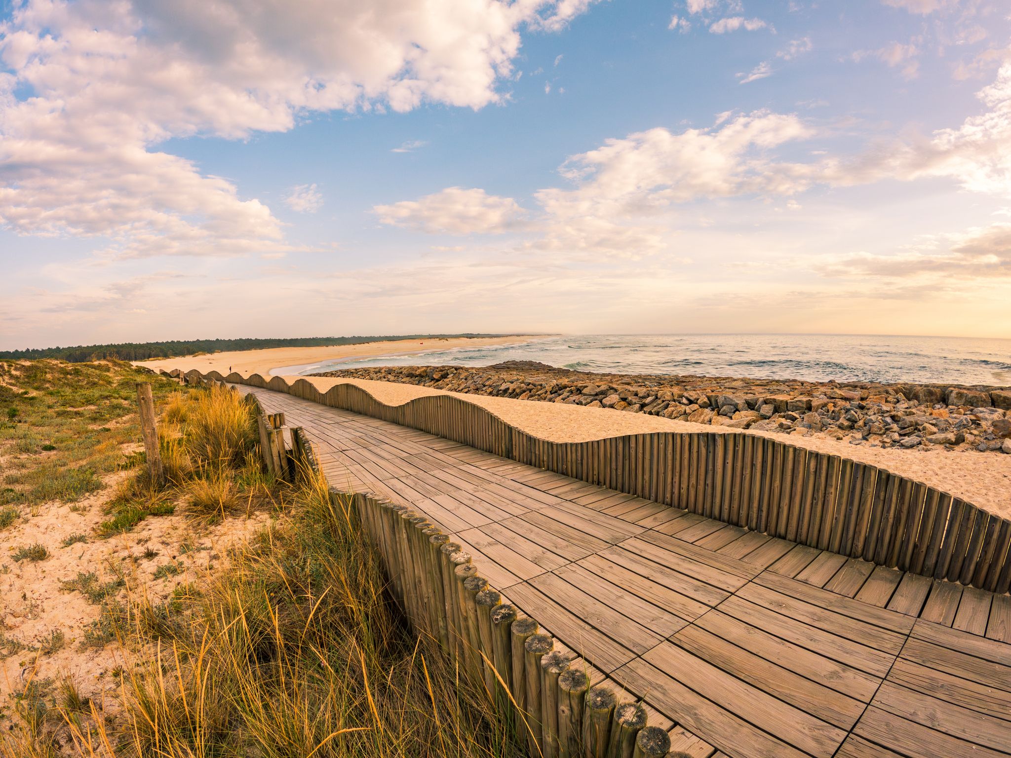 Photo of View from the walkway south of Furadouro beach in Ovar on a stormy day at sunset.