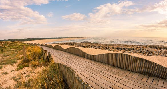Photo of View from the walkway south of Furadouro beach in Ovar on a stormy day at sunset.