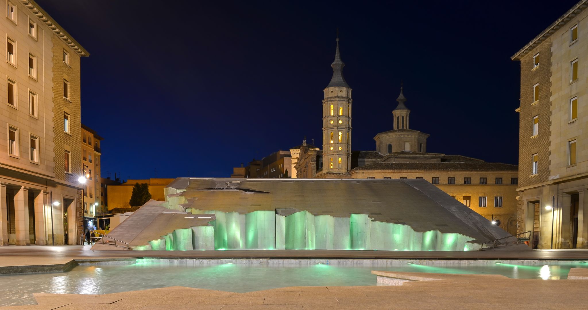 Photo of Zaragoza fountain (Fuente de la Hispanidad) lit up at night in Plaza del Pilar, Spain.