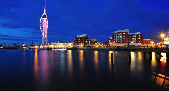 Photo of aerial view of Spinnaker Tower at night and Portsmouth Harbour, England.