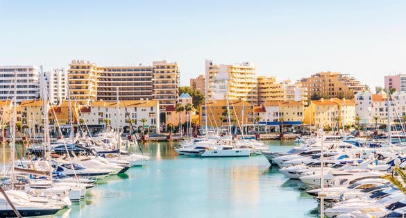 Photo of marina full of luxurious yachts in touristic Vilamoura, Quarteira, Algarve, Portugal.