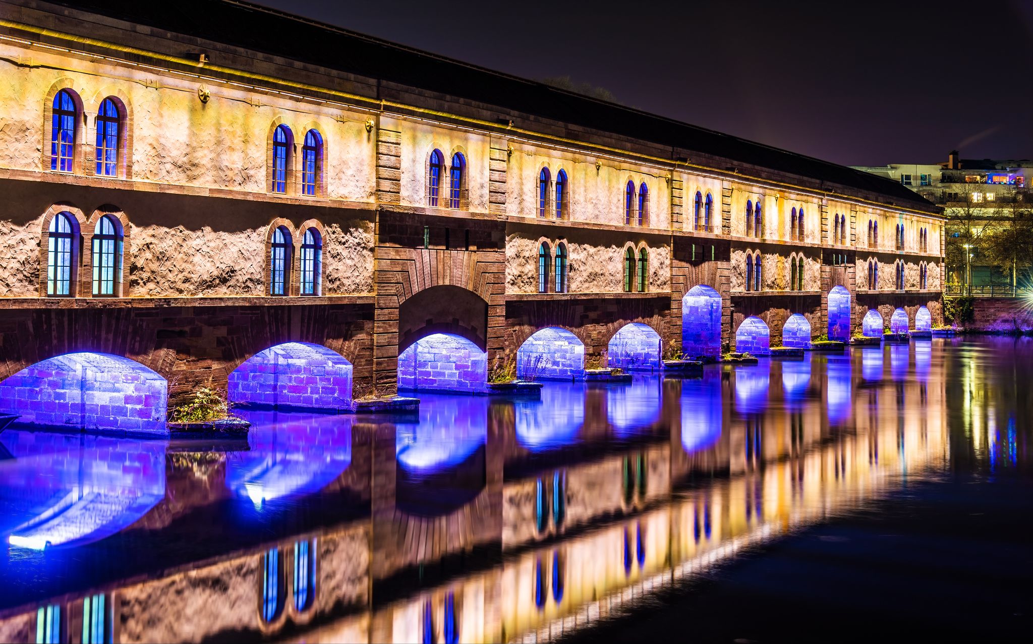 photo of night illumination of Barrage Vauban in Strasbourg, France.