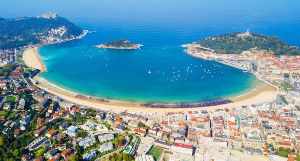 Photo of Santa Clara Island and San Sebastian Donostia city aerial panoramic view, Basque country in Spain.