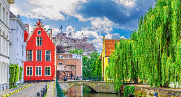 Ghent cityscape, embankment promenade of Lieve water canal, old brick buildings, Ghent historical city centre Prinsenhof Princes Court, Castle of the Counts in Gent old town, Flemish Region, Belgium