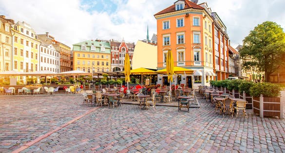 photo of dome square with cafes and restaurants in the old town center in Riga, Latvia.