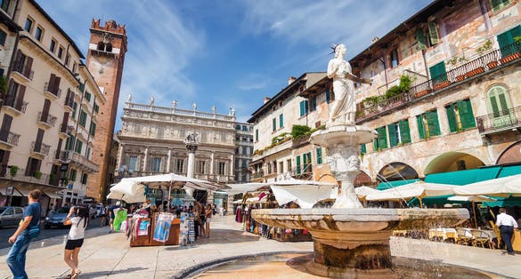 PHOTO OF Sunny view of the Piazza delle Erbe, palazzo Maffei and Gardello tower at historical center of Verona, Veneto region, Italy.