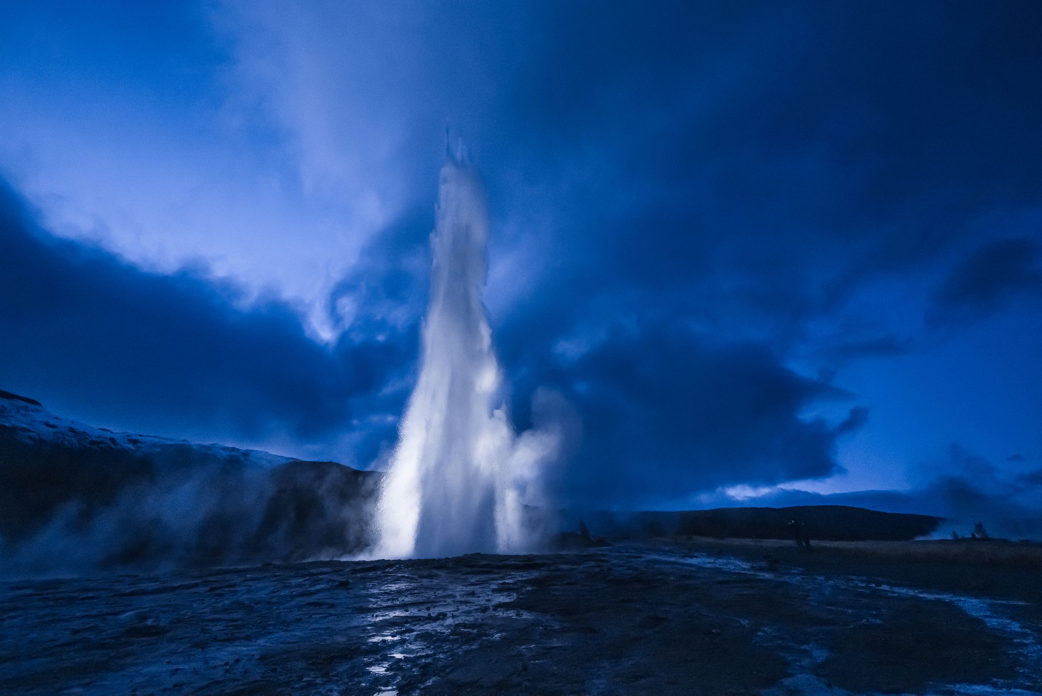 photo of the great geysir at night in Iceland.