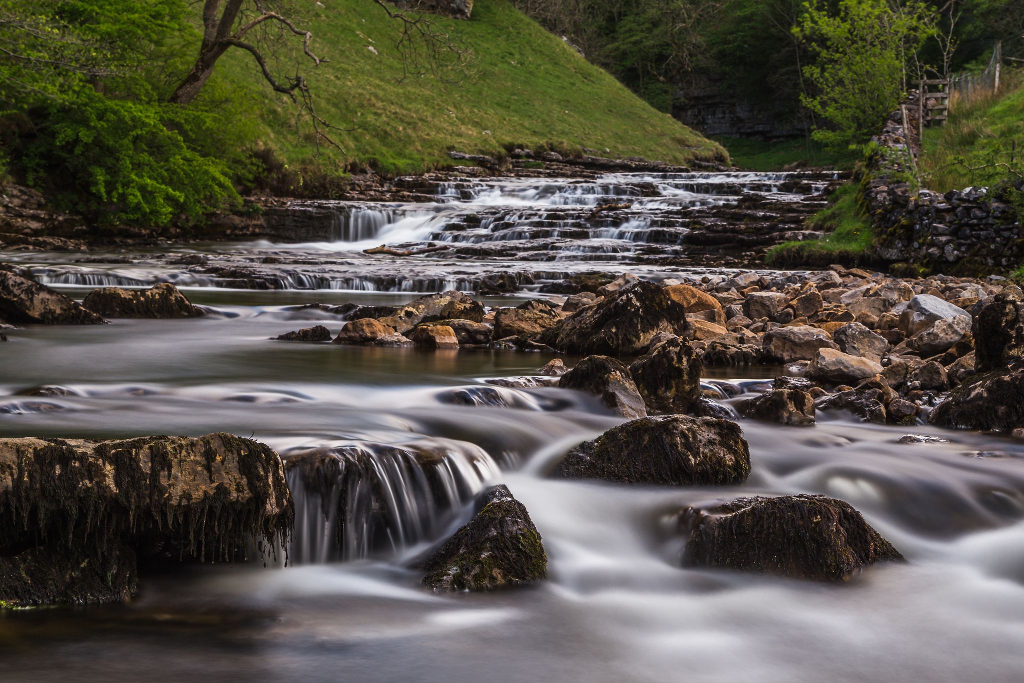 Photo of Water falling over the step-like cascades towards Thornton Force, along the Ingleton waterfalls trail in North Yorkshire.