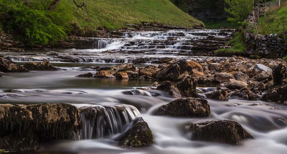 Photo of Water falling over the step-like cascades towards Thornton Force, along the Ingleton waterfalls trail in North Yorkshire.
