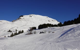 photo of Annecy city center panoramic aerial view with the old town, castle, Thiou river and mountains surrounding the lake, beautiful summer vacation tourism destination in France, Europe.
