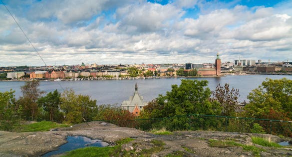 photo of Stockholm from Skinnarviksberget in summer with the town hall in Sweden.