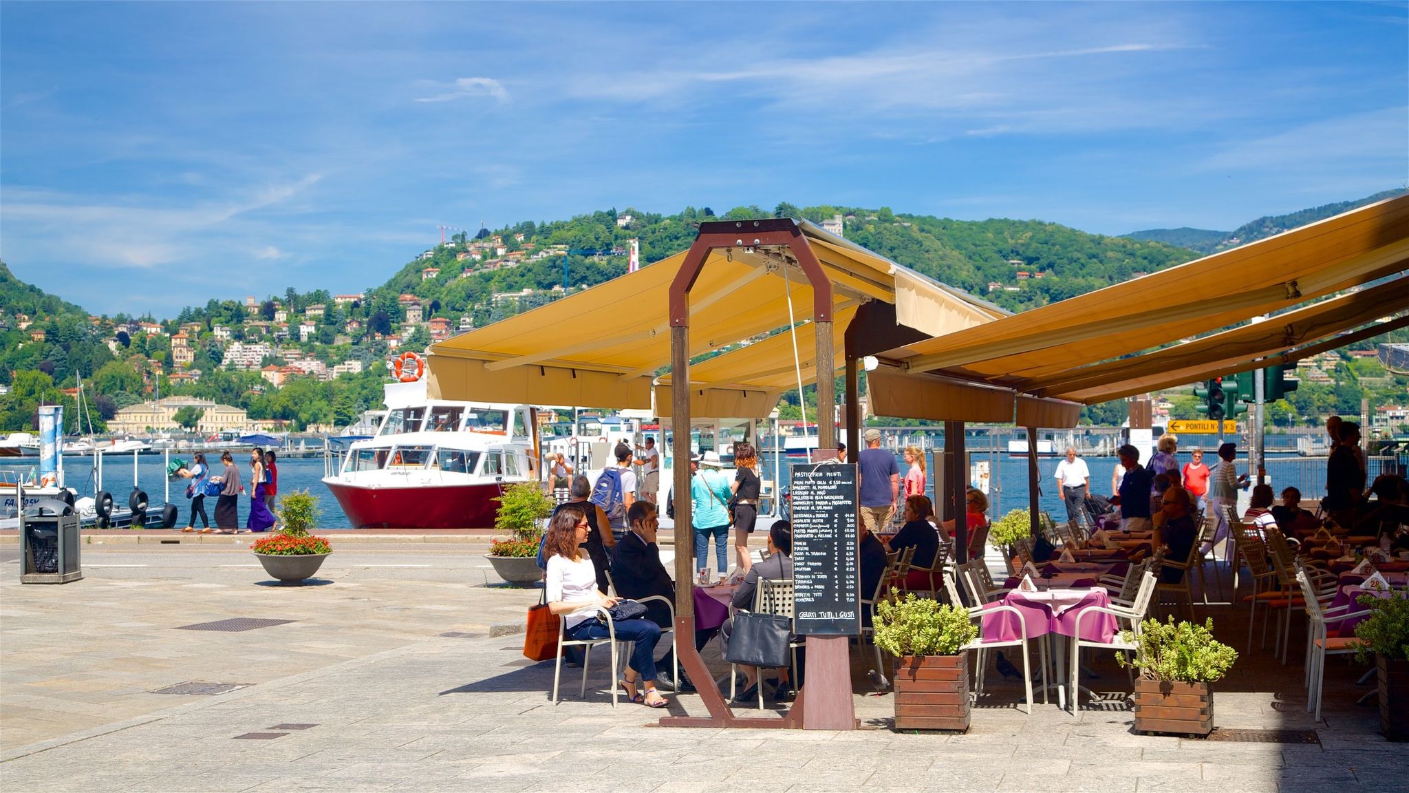 Piazza Cavour showing cafe scenes, a coastal town and outdoor eating