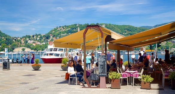 Piazza Cavour showing cafe scenes, a coastal town and outdoor eating
