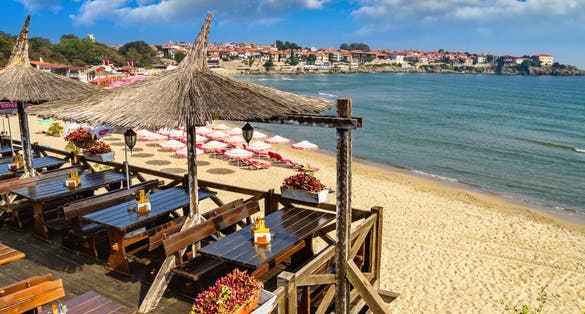 Seaside landscape - view of the cafe and the sandy beach with umbrellas and sun loungers in the town of Sozopol on the Black Sea coast in Bulgaria