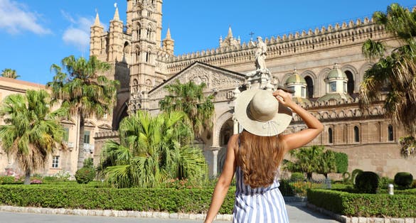 photo of view beautiful girl visiting Palermo Cathedral in Sicily. Summer holidays, palermo, Italy.