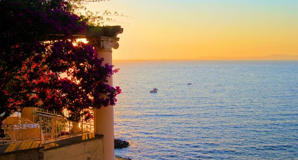 Photo of view from Sorrento, Italy at dusk from a flower draped terrace.