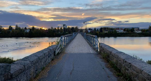 photo of view ofBeautiful sunset over old bridge in Elverum city in Norway.