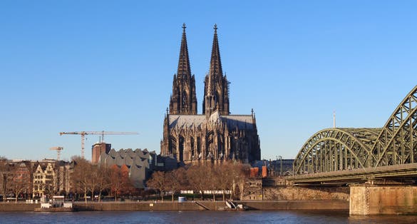 photo of view of The Hohenzollern bridge over Rhine river on a sunny day. The Cologne Cathedral (Kolner Dom) in the city of Cologne, Germany. It is the largest Gothic church in northern Europe.,Cologne Germany.