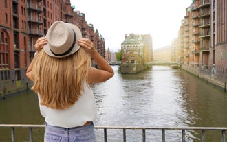 Photo of scenic summer view of the German traditional medieval half-timbered Old Town architecture and bridge over Pegnitz river in Nuremberg, Germany.