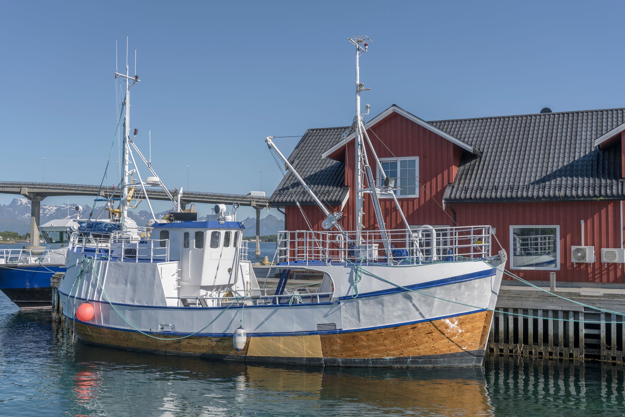 photo of view of traditional picturesque fishing boat, shot under bright summer light at Stokmarknes, Hadseloya, Vesteralen, Norway