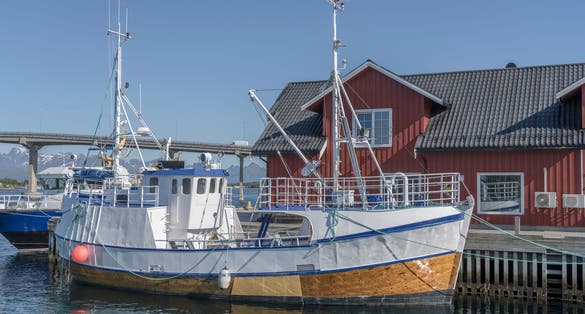 photo of view of traditional picturesque fishing boat, shot under bright summer light at Stokmarknes, Hadseloya, Vesteralen, Norway