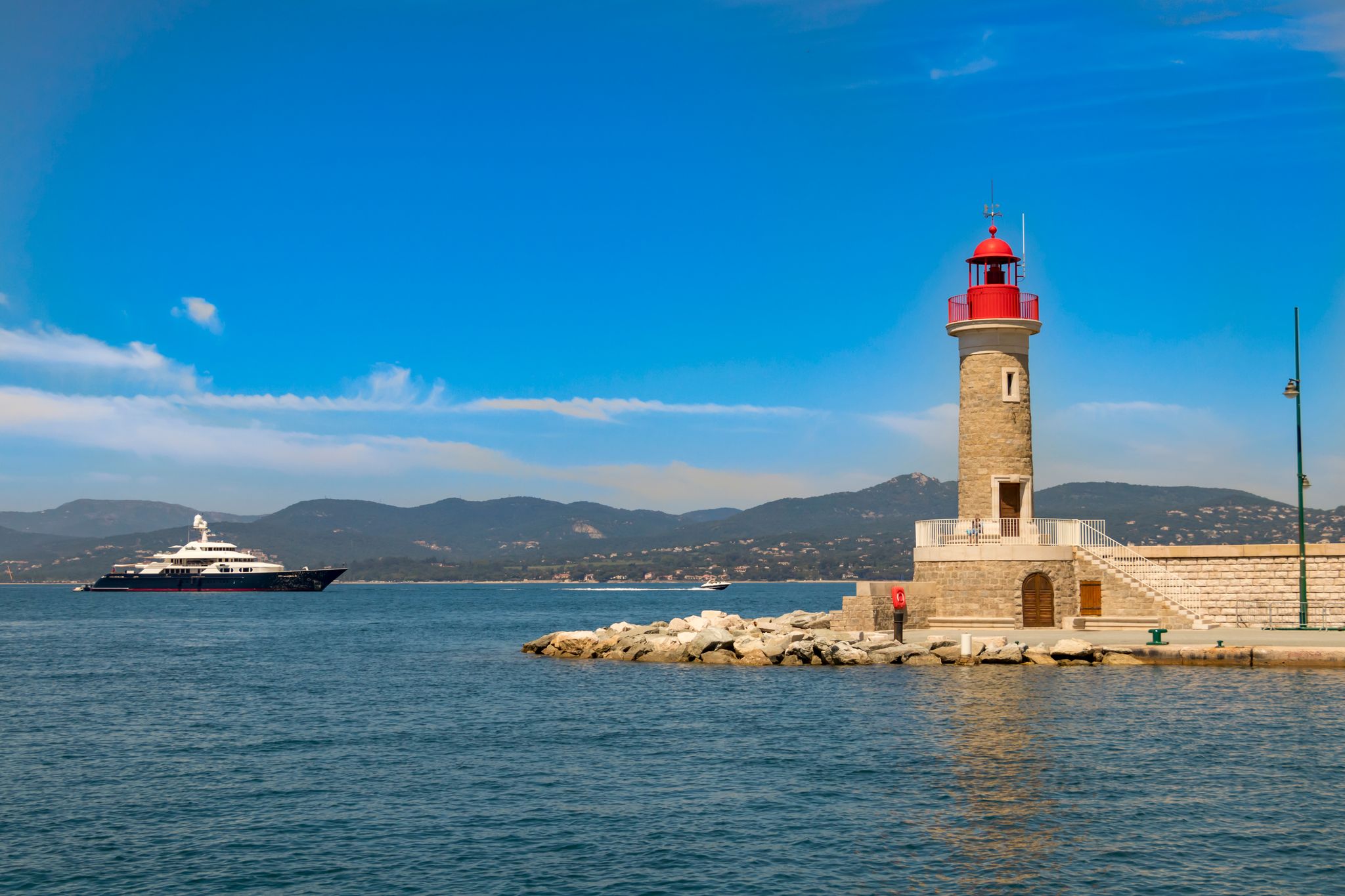 Photo of beautiful aerial view of Saint-Tropez, France with seascape and blue sky.