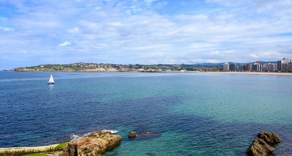 Photo of View on promenade, houses and San Lorenzo beach in Gijon, Asturias, Spain .